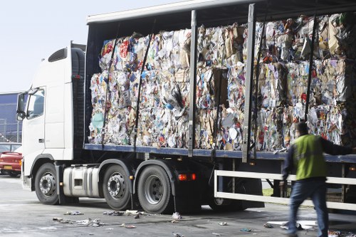 Workers separating recyclables at a clearance site